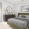a bedroom with a bed and a mirror