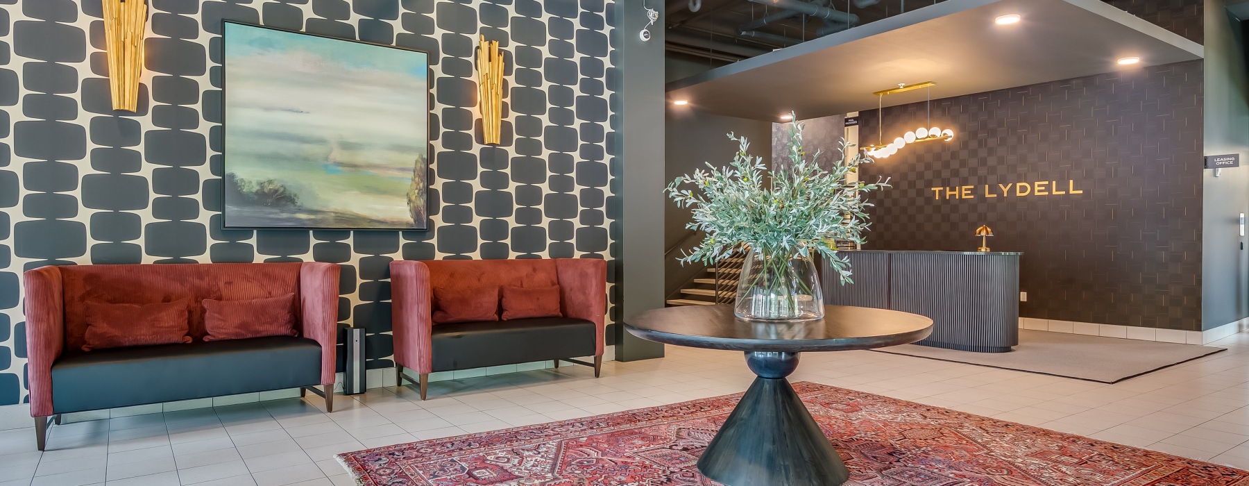 lobby with two couches and a large plant