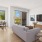 a living room with a grey couch and a tv
